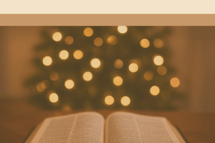 Open Bible with soft Christmas lights in the background, symbolizing Advent devotion and spiritual preparation for Christmas.